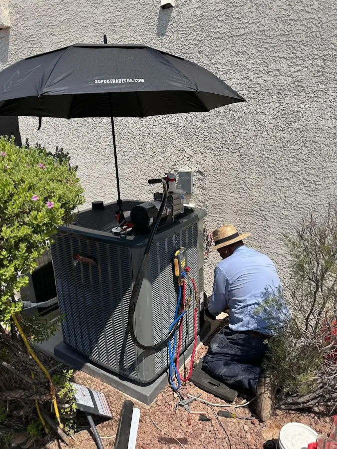 HVAC technician performing outdoor AC maintenance in Deschutes River Woods